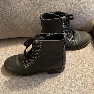 Black ankle tie boots with sparkled trimming. Faux leather